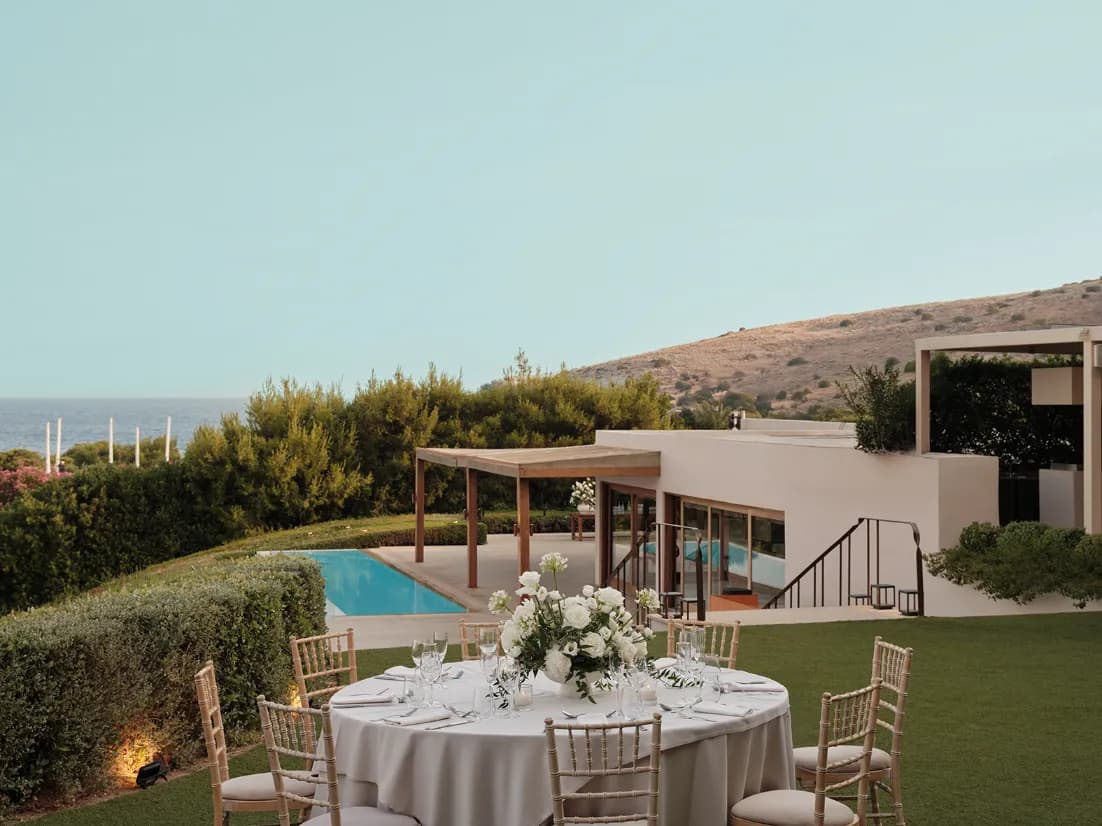 Wedding table beside the pool at a modern seaside villa